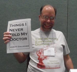 John models his book and his UnDiagnosing T-shirt at Alternatives 2011 in Orlando, FL