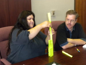 Bonnie Castro and Cameron at a team building event making the largest free standing object from a single piece of paper.