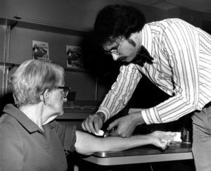 Photograph showed a health professional as he was drawing blood