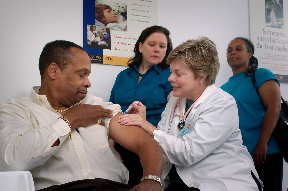 16732-a-nurse-giving-a-middle-aged-man-a-vaccination-shot-pv