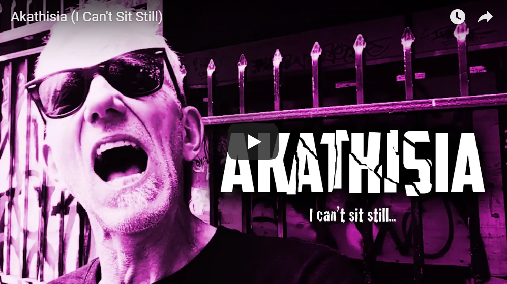 Purple video still with text "Akathisia"