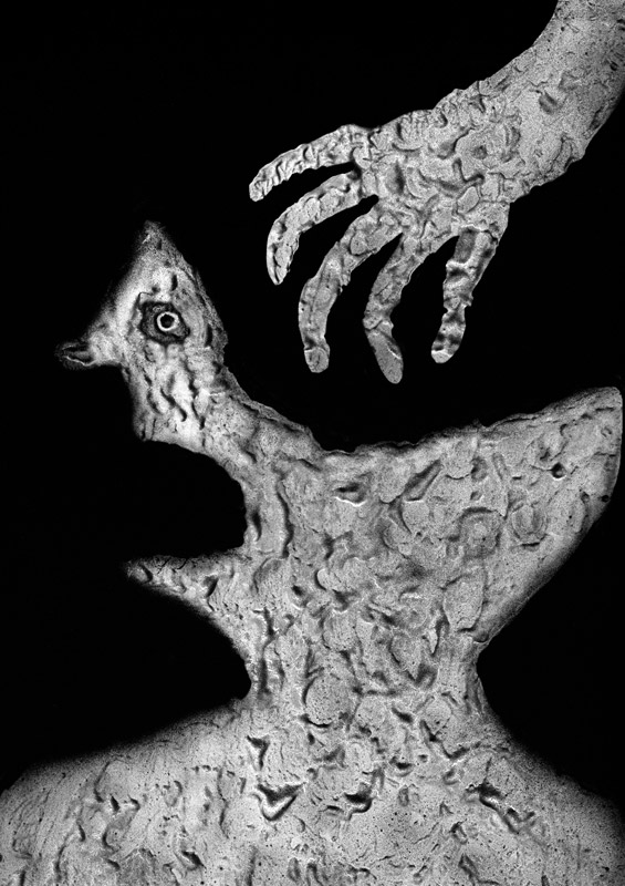 Grayscale person facing left with mouth open and hand coming down from top