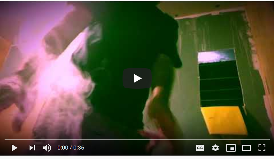 A still from a video in pink and green