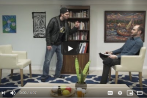 A still from a video with an image of a man in a psychiatrist's office