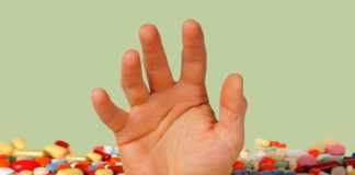The Review on Antidepressant Withdrawal That Cochrane Won’t Publish hand reaching out from pile of pills