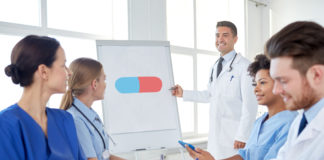 Turning the Corner: How Are We Educating Psychiatrists in Medical Schools? medical lecture pointing at pill drawing