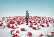 National Boards of Health Are Unresponsive to Children Driven to Suicide by Depression Pills lone man standing among giant pills