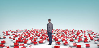 National Boards of Health Are Unresponsive to Children Driven to Suicide by Depression Pills lone man standing among giant pills