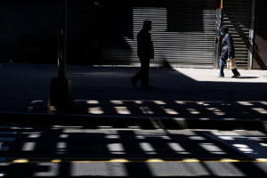 a person stands alone in silhouette in the shadows