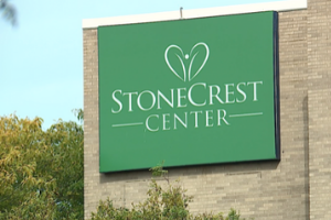 Green sign that says "Stonecrest Center"