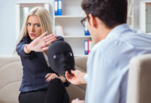 Should You Ever Ask Someone “Are You Suicidal?” woman rejecting mask held by psychiatrist