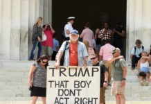 The President’s Fitness: Can Professionals Help Decide? Man holds sign reading "TRUMP THAT BOY DON'T ACT RIGHT"