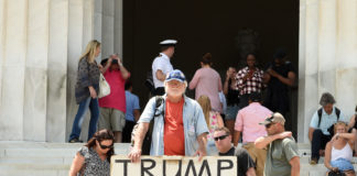 The President’s Fitness: Can Professionals Help Decide? Man holds sign reading "TRUMP THAT BOY DON'T ACT RIGHT"