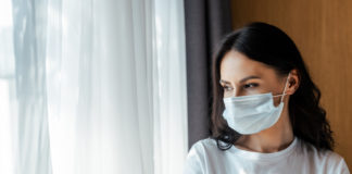 Loneliness Is Deadlier Than COVID woman wearing medical mask