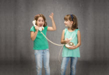 Three Recent Genetics Books and Twin Studies’ Indefensible “Equal Environment Assumption” twins using a phone