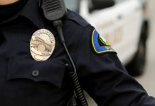 Defunding the Police: Replacing Guns With Prescription Pads Is Not the Answer close-up of a police badge