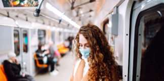 Is It Time to Rethink Mental Illness in Light of the Pandemic? woman wearing surgical mask on train