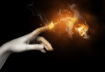 Whose Finger is Taking the Pulse of America’s Shock Treatment Controversy? hand touching orange electricity