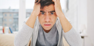 SSRI Withdrawal’s Elephant in the Room: Tardive Akathisia man looking upset with pills in front of him