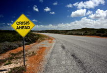 Insane Medicine, Chapter One: The Medical Model of Mental Health Is Finished road sign reads "crisis ahead"