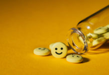 Insane Medicine Chapter 5: The Manufacture of Childhood Depression (Part 2) spilled pills with happy faces on them
