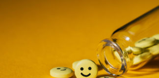 Insane Medicine, Chapter 5: The Manufacture of Childhood Depression (Part 2) spilled pills with happy faces on them