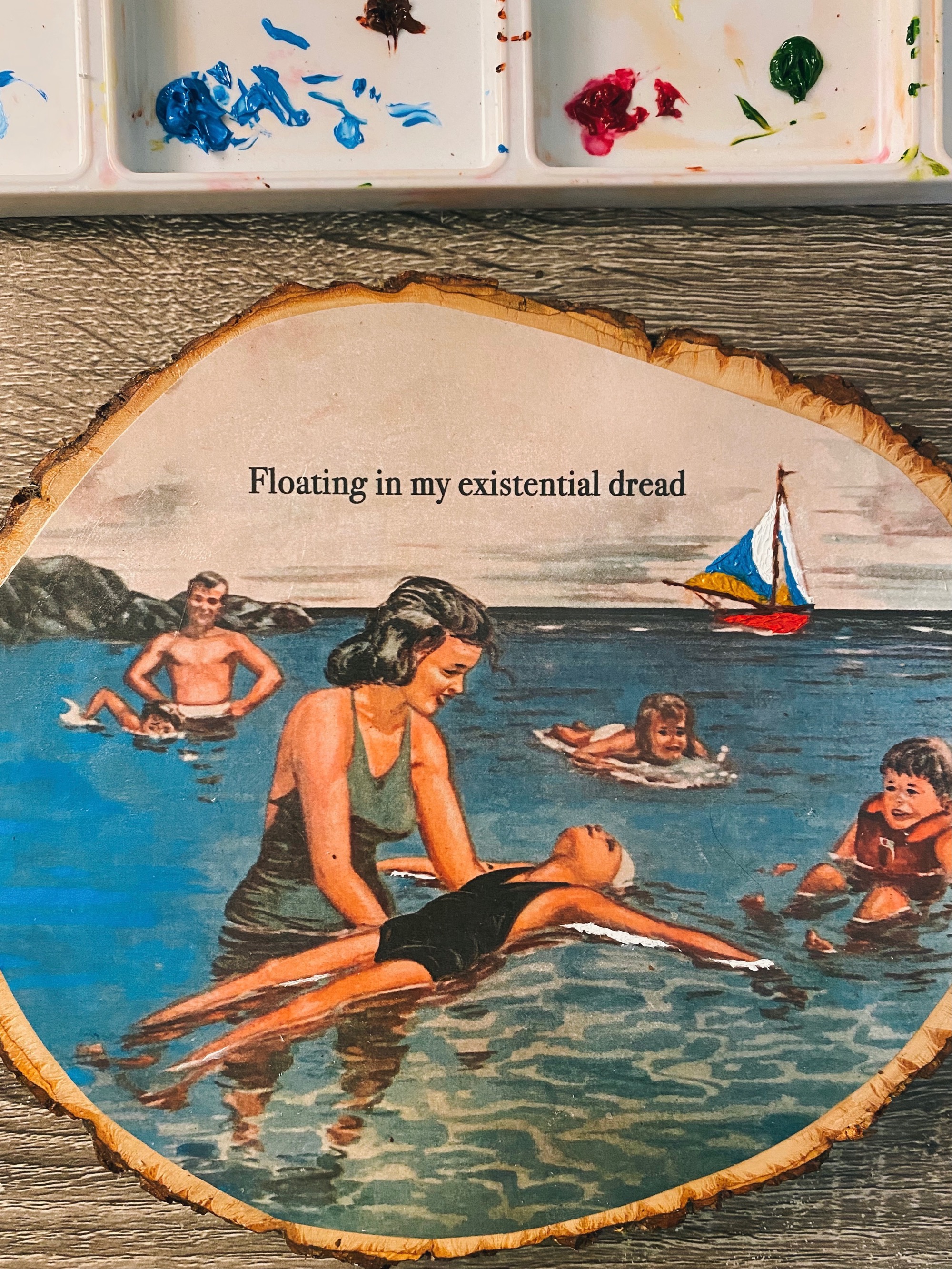 Floating in My Existential Dread by Julia Parker A photo of a woman holding a child floating in the water on a piece of wood
