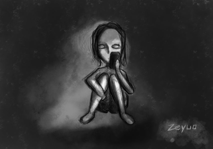 A child looking at a phone in the dark