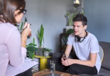 Bringing Rights-Based Approaches to Mental Health to College Counseling Teenage boy meeting with female psychologist