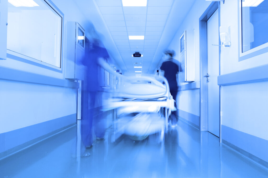 Hospital bed in a modern clinic corridor