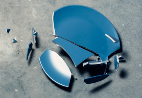 Photograph of a blue plate shattering