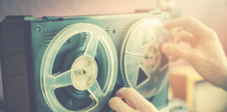 The Cochrane Tapes Reveal a Horrendous Show Trial Against a Critic of Psychiatry photo of hands fiddling with a reel to reel tape recorder