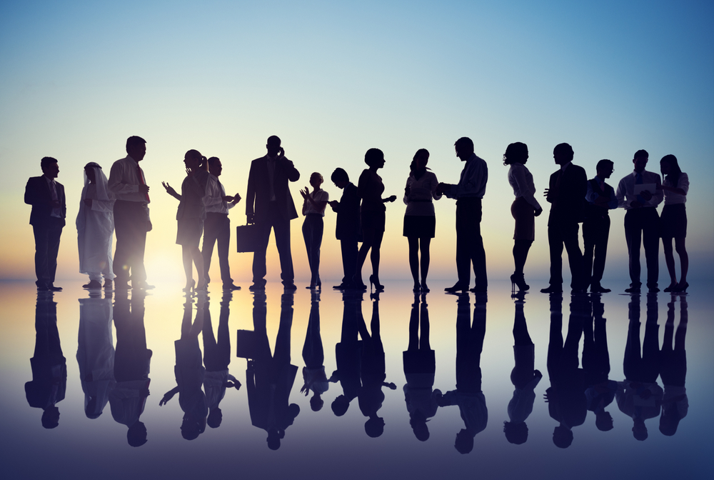 Photograph, silhouettes of businesspeople gathering outdoors