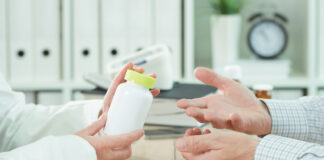 Psychotherapy Has an Enduring Effect on Depression—in Contrast to Depression Pills closeup photo of two people's hands; one holding a pill bottle and one making a questioning gesture