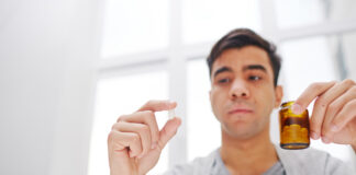 guy holding pill