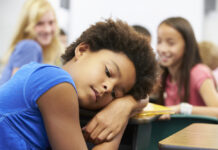 Q&A: My Child Is Suicidal. What Should I Do? young, sad Black girl being bullied at school