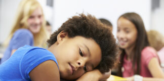 Q&A: My Child Is Suicidal. What Should I Do? young, sad Black girl being bullied at school