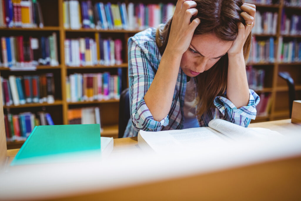 Photo of student in the library at the university