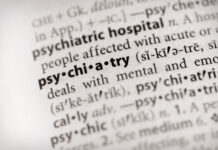 Why Is Psychiatry So Defensive About Criticism? Photo: selective focus on the word "psychiatry" in a dictionary