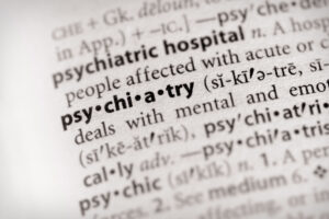 Photo: selective focus on the word "psychiatry" in a dictionary