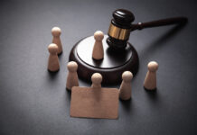 Guardianship Destroyed My Family Wooden pawn-like figures surrounding a gavel