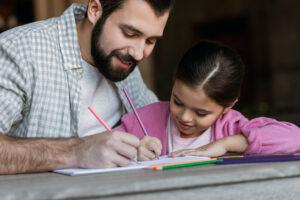 Father helping his daughter with homework