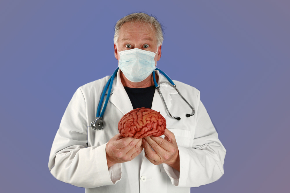 A doctor holds a brain