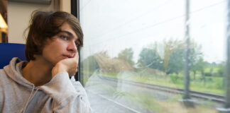 Patient Reports Reveal SSRI Antidepressants Often Lead to Emotional Blunting Bored young man, staring out the train window on a rainy, grey and dull day