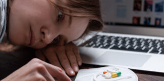 Antidepressants Do Not Improve Quality of Life Image of a young girl looking at a handful of antidepressants.