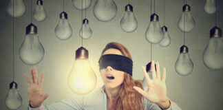 The Emperor’s New Clothes: The Upcoming NICE Depression Guidelines Concept illustration: Blindfolded young woman walking through lightbulbs