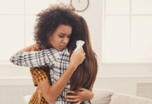 Treating Grief with Addiction Drug Jeopardizes Social Connections Woman hugging her friend at home