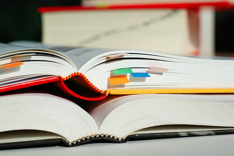 Close-up photo of two textbooks, open, one on top of the other