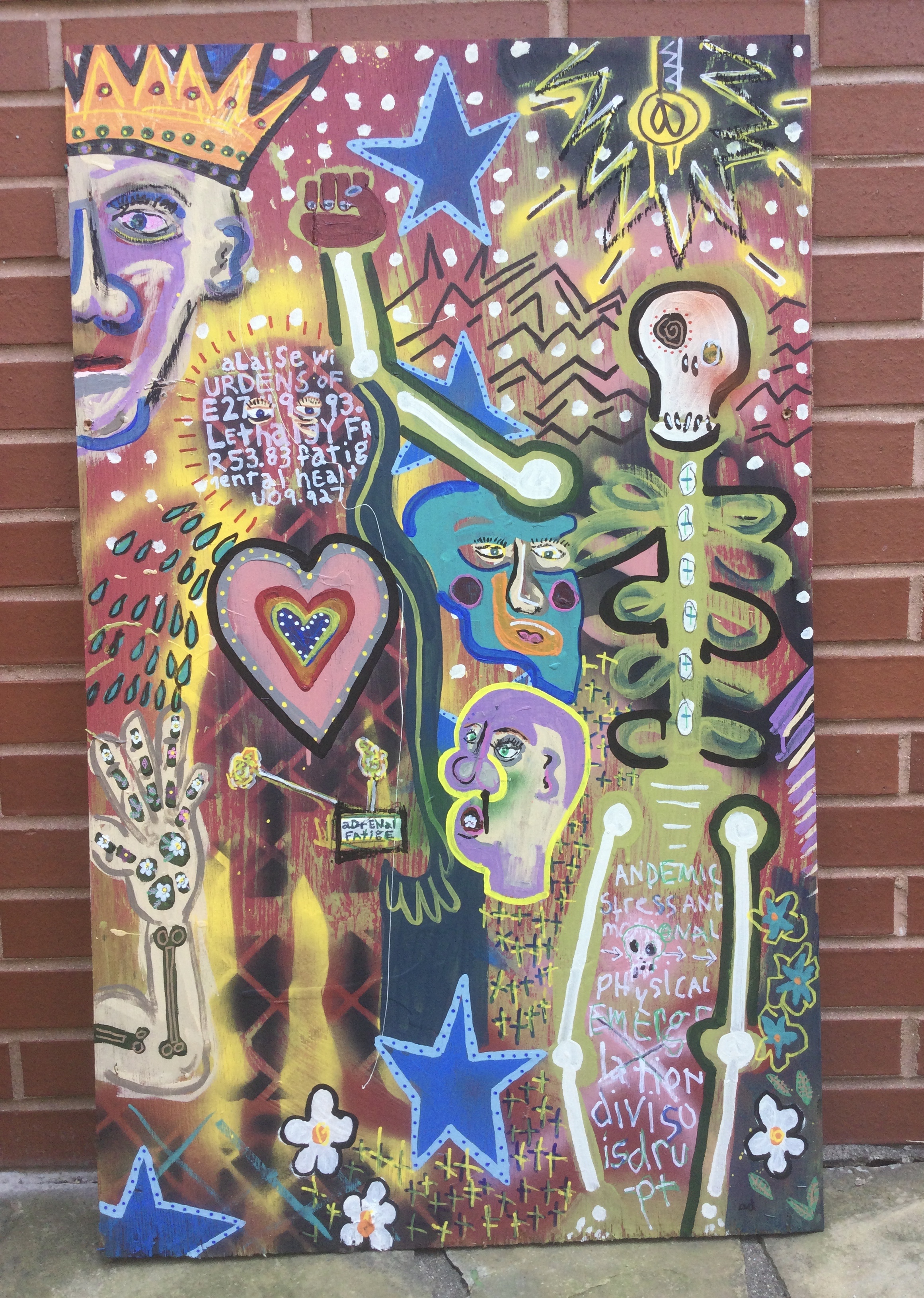 painting against a brick wall, vibrant colors depict a skeleton, king, faces surrounded by stars, flowers, hearts and dots.