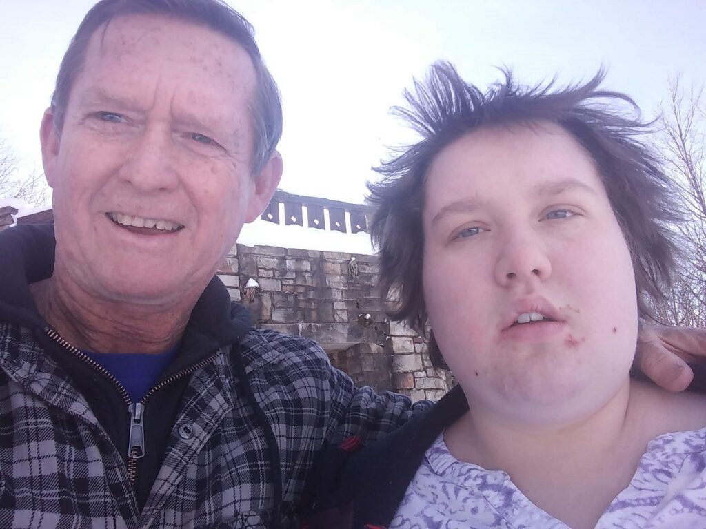 A middle-aged white man and his heavyset, dark-haired adolescent daughter